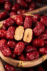 closeup of dried red dates on wooden table.