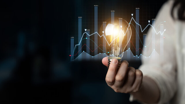 A conceptual image illustrating a light bulb held by a person in front of a data chart, symbolizing business growth and innovation in a dynamic market landscape. Scalp