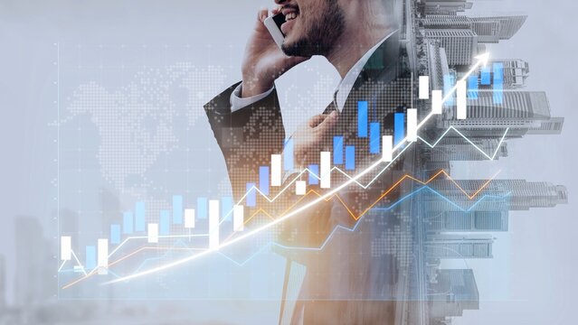 A professional businessman engaged in a phone conversation stands confidently in front of an upward-trending financial graph, symbolizing growth and success in business. Copula