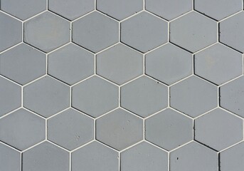 Geometric seamless pattern of gray hexagonal tiles with white grout lines