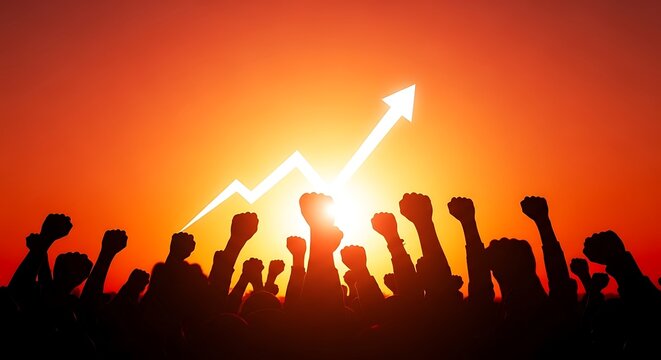 Silhouette of a crowd raising fists in the air against a vibrant sunset, symbolizing success, growth, and achievement background image