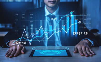 A businessman analyzes financial growth trends displayed on a tablet, featuring dynamic graphs and stock market data in a modern office, symbolizing success. Scalp