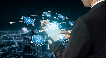 A businessman interacts with a tablet displaying digital icons related to enterprise resource planning, symbolizing innovation and technology in a modern urban setting. Tessel