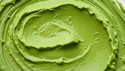 Green cosmetic clay (cucumber facial mask, avocado face cream, green tea matcha body wrap) texture close up, selective focus. Abstract background with brush strokes, photo. White tone