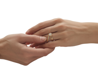 Man's hand gently holds woman's hand wearing engagement ring