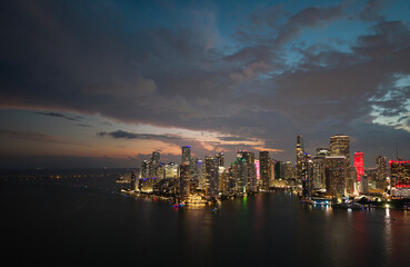 Fototapeta premium Famous landmarks of Miami Brickell from above at night. Drone view of the Brickell in Miami city. Business in Brickell district. Biscayne Bay Florida iconic urban coastline in daylight.