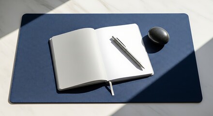 Minimalist Workspace - Notebook, Pen, and Mouse on Blue Desk Mat.