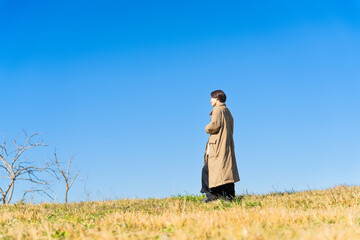 丘を歩く女性　ライフスタイルイメージ