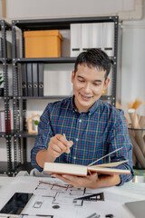 A young architect is multitasking at his desk, sketching blueprints, making phone calls, and reviewing notes. His workspace shows focus, productivity, and modern design work.