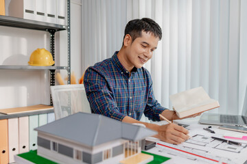 A young architect is multitasking at his desk, sketching blueprints, making phone calls, and reviewing notes. His workspace shows focus, productivity, and modern design work.