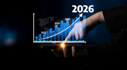 A business professional interacts with a digital growth chart displayed on a tablet, highlighting projected increases in revenue from 2023 to 2026, symbolizing progress. Tessel