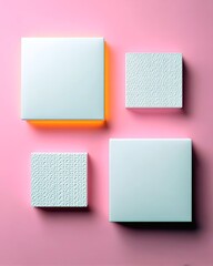 Fototapeta premium Four square shapes, two smooth and two textured, are arranged on a pink background with subtle lighting.