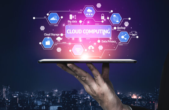 A hand holds a tablet displaying vibrant cloud computing graphics, symbolizing advanced data management and connectivity in a modern urban environment. Tessel