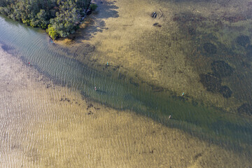 A breathtaking aerial view of Forster on the Mid North Coast of New South Wales, showcasing turquoise ocean waters, white sandy beaches, and the bridge linking Forster and Tuncurry. The scenic coastli