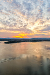 A breathtaking aerial view of Forster on the Mid North Coast of New South Wales, showcasing turquoise ocean waters, white sandy beaches, and the bridge linking Forster and Tuncurry. The scenic coastli