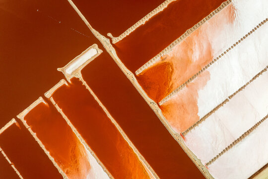 Red salt ponds divided by pale geometric walls