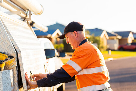 Middle aged man closing side of tradie handyman ute