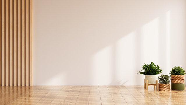 Fototapeta Modern minimalist interior with natural wooden floor and wall panels, decorated with green potted plants in sunlight- 3D rendering