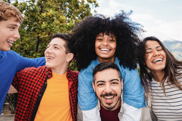 Happy multiracial friends having fun together outdoors - Group of young people smiling and laughing in city street