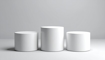Three white cylinders, varied height, on a plain backdrop
