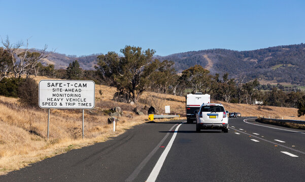 safe-t-cam site ahead monitoring heavy vehicle speed and trip times sign beside highway