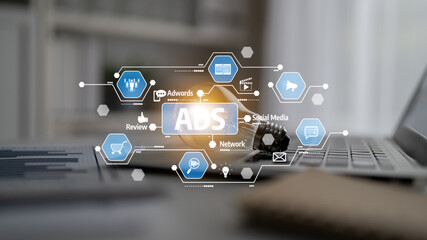 Innovative digital marketing concept displaying various ads icons and symbols over a laptop in a modern office setting, showcasing the essence of online advertising strategies. Tessel