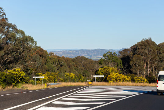 arrester bed signs beside highway going down long hill in Australia