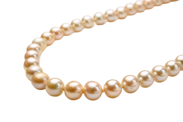 Strand of lustrous cream and peach colored pearls against a black background necklace jewelry