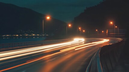 Obraz premium illuminated trails unveil nocturnal charm, capturing long exposure motion and light paintings on a winding road under a dark sky expanse