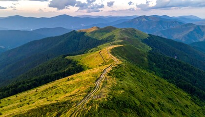 Aerial view of a mountain ridge with lush green meadows and distant peaks