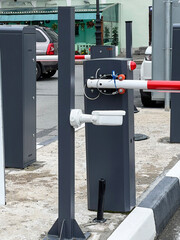 Modern traffic barrier stands at entrance to parking structure in urban area