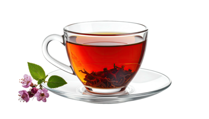 Clear teacup with dark tea and pink flowers, on black background