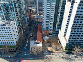 Aerial view of small city construction site between highrise buildings