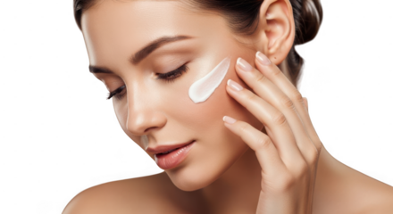 Young woman applying facial cream or lotion with eyes closed in skincare routine isolated on transparent background