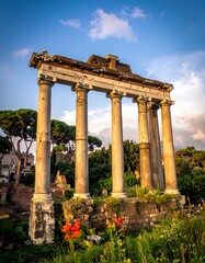 Ancient classical columns stand tall under a beautiful cloudy sky at sunset
