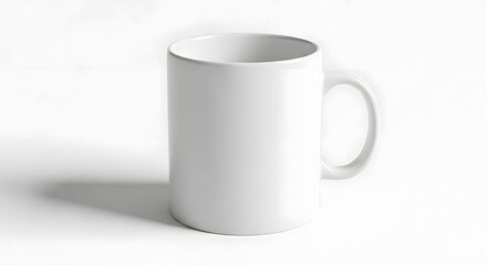 Obraz premium Blank white ceramic mug casting a shadow on a plain white background, perfect for product mockups and customizable designs