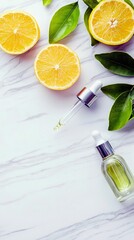 A flat lay composition featuring sliced lemons, fresh green leaves, and two glass droppers, one with liquid, on a white marble background.