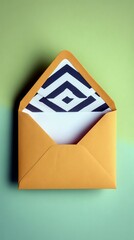 An open yellow envelope with a white paper insert and a black and white geometric pattern lining is displayed against a two-toned green background.