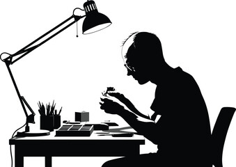 Focused desk work silhouette, black and white, hobbyist at table, model building, precision tools, lamp, workspace, concentration, creative activity