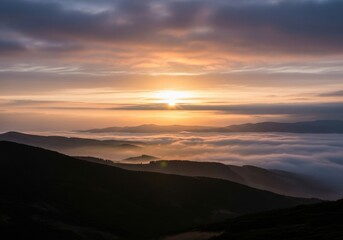 Obraz premium Stunning sunrise over rolling hills with misty clouds and dramatic sky colors