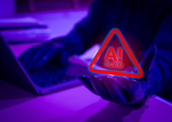 Gloved hand holding scam warning hologram with laptop in background, representing AI scam alert, cybercriminal activity, fraud detection, and technology-based scams using artificial intelligence.