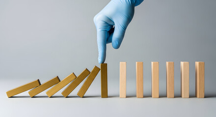 Business and Health Care Protection during Coronavirus Situation Concept. Hand with Medical Glove Blocking Domino Effect