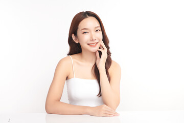 A beautiful young Asian woman with clean, fresh skin against a white background. Skincare, facial treatment, cosmetology, beauty, and spa. An elegant portrait of an Asian woman.