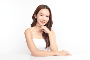 A beautiful young Asian woman with clean, fresh skin against a white background. Skincare, facial treatment, cosmetology, beauty, and spa. An elegant portrait of an Asian woman.