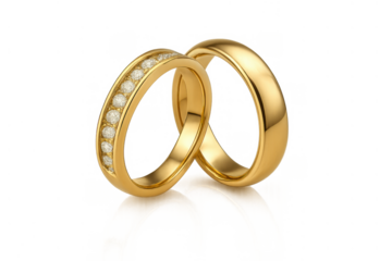 Two gleaming gold wedding bands, one with diamonds, are interlocked, representing union and eternal love, on a transparent background