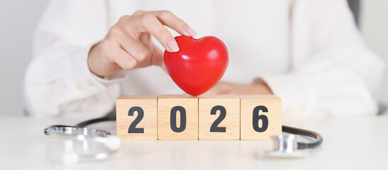 Happy New Year 2026 with Stethoscope of doctor and heart shape on table. health care, Insurance, Wellness and medical concepts