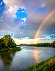 Stunning double rainbow arcs over a river scene after a rainstorm