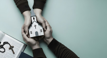 Praying, Spirituality, Religion and Hope Concepts. Two People Embracing a Wooden Model Chirstian Church Together. Bible and Cross as background. Banner Size. Top View
