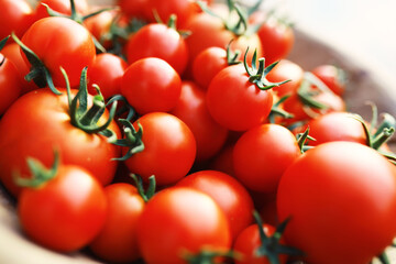 Ecological fresh farm cherry tomatoes on a wooden background.