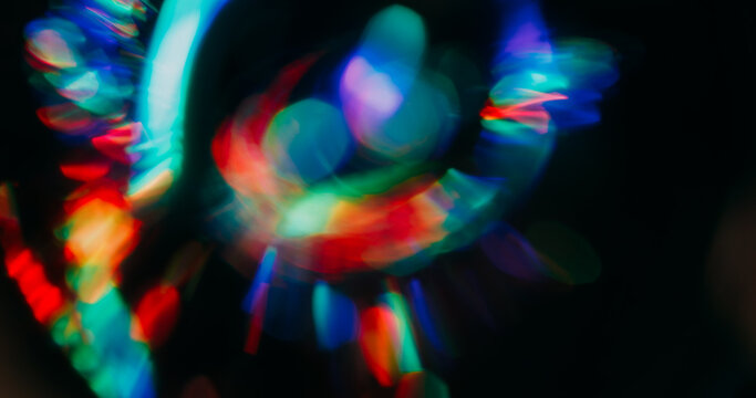 Gradient bokeh reflection. Shimmering glow. Red green circles sparks flow on black background. Colorful beam defocused abstract texture. - Powered by Adobe
